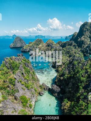 Secret lagoon in El nido. couple enjoying time in the crystal transparent water and kayaking. Concept about traveling and nature