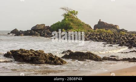 The idyllic Om beach with a small rocky promontory jutting into the sea in the coastal village of Gokarna. Stock Photo