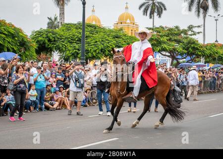 Chalán on horseback entertaining the crowds in the main square at the Marinera dance festival parade in Trujillo Peru Stock Photo