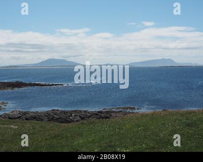 Achill Island, Erris, Co. Mayo, Ireland seen from Doonamoe Point, Gladree. The two peaks are Slievemore (left) and Croaghaun. Stock Photo