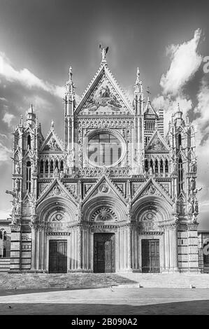 View of the facade of the gothic Cathedral of Siena, Tuscany, Italy. Completed in 1348, the church is dedicated to the Assumption of Mary and it is on Stock Photo