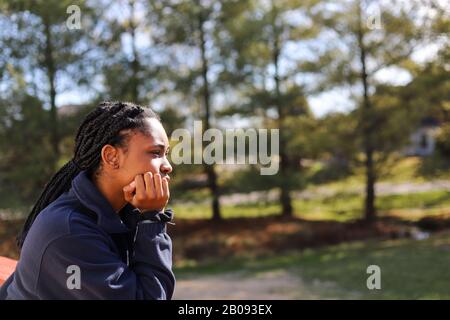 portrait of an African-American teenaged girl looking away in deep thought