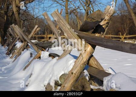 Wooden fence near the Hartwell Tavern along the Battle Road at Minute Man National Historical Park in Lincoln, Massachusetts during the winter months. Stock Photo