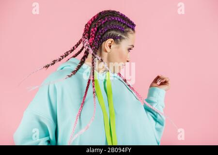 A girl with a fashionable set of multicolored braids Kanekalon. Colored artificial strands of hair. Stock Photo