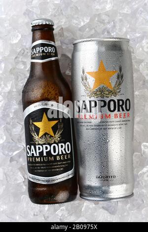 IRVINE, CA - JANUARY 12, 2015: A can and bottle of Sapporo Beer on a bed of ice. The Japanese brewery was founded in 1876 by German trained brewer Sei Stock Photo