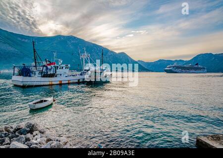A Cruise ship and a fishing boat in the Bay of Kotor Stock Photo