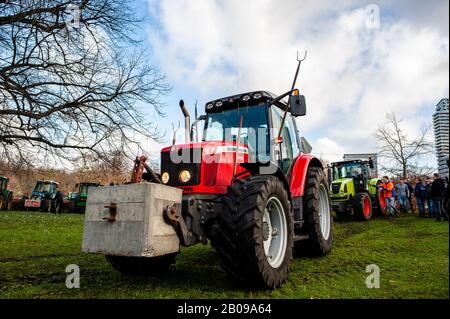 A view of tractors parked on the grass during the protest.Thousands of Dutch farmers under the motto 'all brakes off' are protesting against the measures proposed to cut down on nitrogen emissions at the Malieveld, in The Hague. The Mesdag Fund has instructed the University of Amsterdam to start a three-year study into the precipitation of nitrogen in nature reserves and to find out exactly where nitrogen emissions from livestock farms end up. After several meetings with the Dutch government, farmers keep waiting for a solution of the nitrogen problem. The nitrogen debate in the Lower House wi Stock Photo