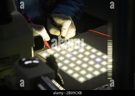 Worker testing a LED light lamp Stock Photo
