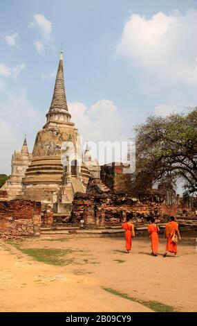 buddhist monk in traditional orange robe touching rock Stock Photo - Alamy