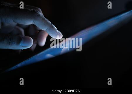 Close up of man finger pointing on digital tablet  Stock Photo