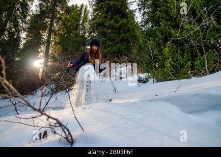 Girl in the winter forest on snowshoes. Winter outdoor tourism Stock Photo