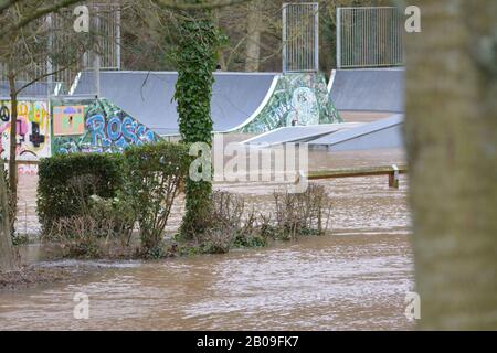 River Wye burst its banks at Ross-on-Wye Herefordshire UK with water covering fields and skate park re flooding global warming climate Stock Photo