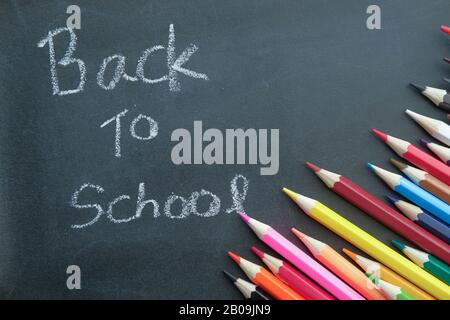 back to school text on blackboard with color pencils  Stock Photo