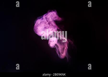 Abstract neon light smoke effect on black background. Smoke cloud explosion. Stock Photo