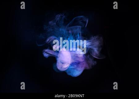 Abstract neon light smoke effect on black background. Smoke cloud explosion. Stock Photo