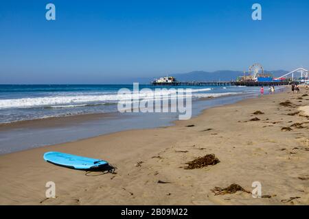 Abandoned surfboard on the beach at Santa Monica, Los Angeles, California, USA Stock Photo