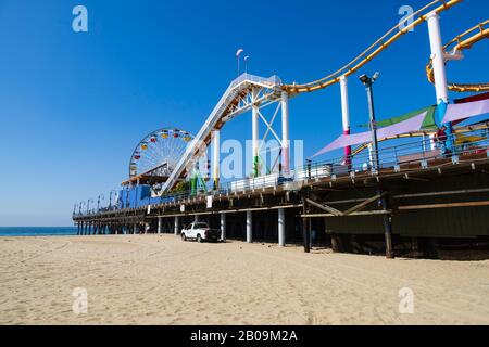 Big wheel and roller coaster amusements on Santa Monica pier, Los Angeles, California, United States of America