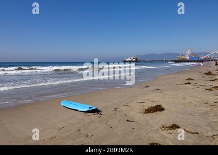 Abandoned surfboard on the beach at Santa Monica, Los Angeles, California, USA Stock Photo