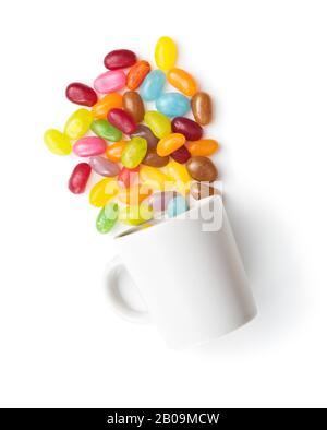 Fruity jellybeans. Tasty colorful jelly beans in cup isolated on white background. Stock Photo