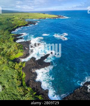 An aerial view of the coastline at Waianapanapa State Park, Hana, Maui, Hawaii. The famous black sand beach is in the bay at the top of the frame. Fiv Stock Photo