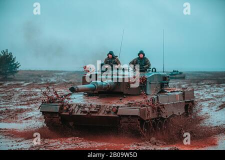 Polish Soldiers, assigned to the 1st Warsaw Armored Brigade operate a Leopard 2 tank during a multinational training scenario in support of NATO enhanced Forward Presence Battle Group Poland February 6, 2020 in Bemowo Piskie, Poland. The NATO enhanced Forward Presence consists of four battalion-sized battle groups deployed on a persistent rotational basis to Estonia, Latvia, Lithuania and Poland. Stock Photo