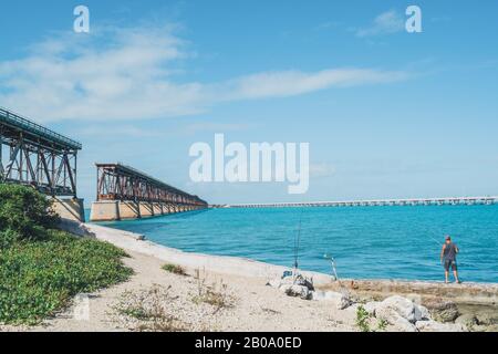 Bahia Honda State Park, Florida Keys - JAN 19, 2020.  Man fishing in crystal clear waters near old overseas highway bridge Stock Photo