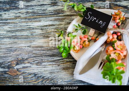 Festive table place setting with spring blossoming branch on wooden background. Copy space Stock Photo