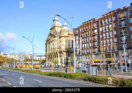 Budapest, Hungary - Nov 6, 2019: Historical buildings in the center of the Hungarian capital city on a vertical photo. Road and train station in the foreground. Eastern European cities. Stock Photo