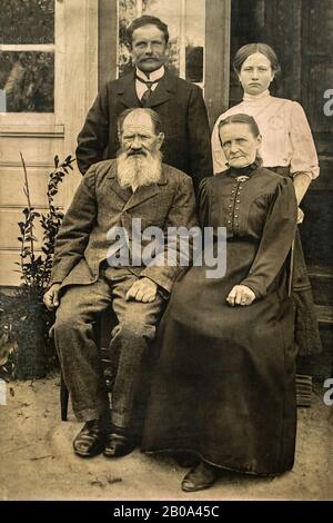 RUSSIA - CIRCA 1905-1910: Shot of elderly married couple with their adult son and daughter in studio , Vintage Carte de Viste Edwardian era photo Stock Photo