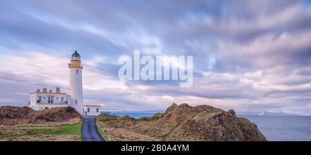 The Magnificent lighthouse at Turnberry on the Ayrshire Coast with Ailsa Craig and Arran hills in the misty background. Turnberry area and nearby Girv Stock Photo