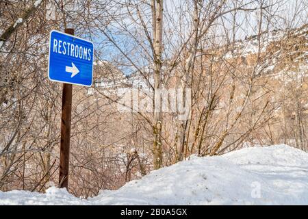 restrooms sign in one of rest areas in Glenwood Canyon, Colorado in winter scenery, travel concept Stock Photo