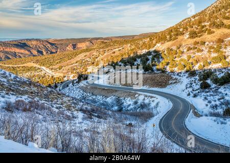 scenic windy mountain road in winter scenery - La Sal Mountain Loop near Moab Utah, travel concept Stock Photo