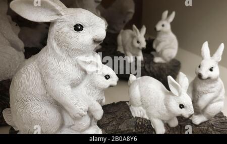 A group of Easter rabbits, white stone figurines, home decorations for Easter holdiay Stock Photo