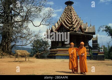 CHINA,XISHUANG BANA,MONKS IN FRONT OF A PAGODA Stock Photo