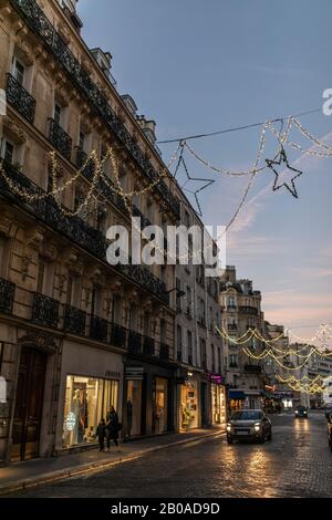 Holiday lights and store windows on a street in Passy, Paris, France Stock Photo