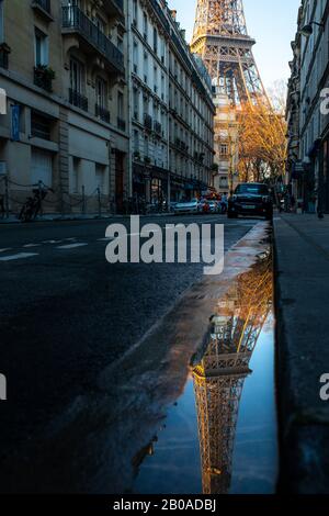 A reflection of the Eiffel Tower on a street in Paris, France. Stock Photo