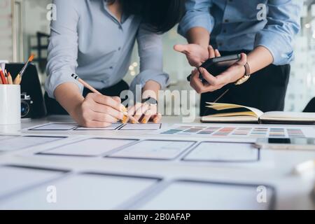 Programmer and UX UI designer working in a software development and coding technologies. Mobile and website design and programing development technolo Stock Photo