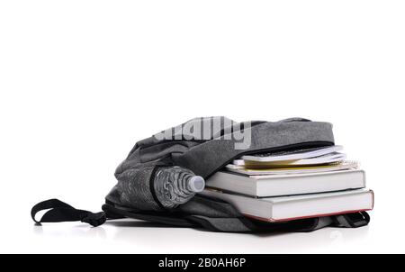 School backpack on a white background with books and spiral notebooks Stock Photo