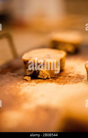 Unbaked chocolate chip cookie dough on oven stone with blurred background close up Stock Photo