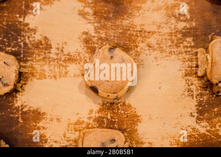 Unbaked chocolate chip cookie dough on oven stone top down Stock Photo