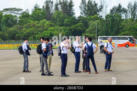 Singapore - Feb 12, 2020. Visitors looking at military aircrafts in Changi, Singapore. Defense costs are increasing, especially in East Asia. Stock Photo