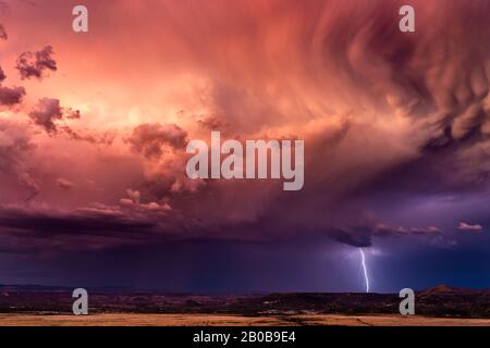 Stormy sky with dramatic clouds and lightning at sunset