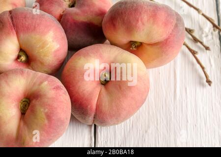 Donut peaches on white rustic table - horizontal closeup image with selective focus Stock Photo