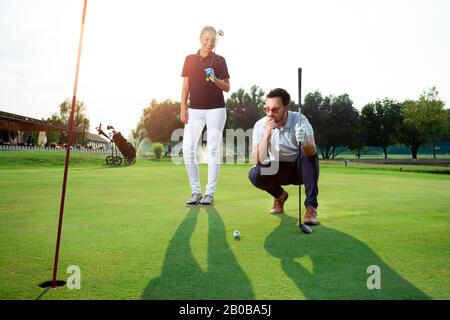 A beautiful couple playing golf. Stock Photo