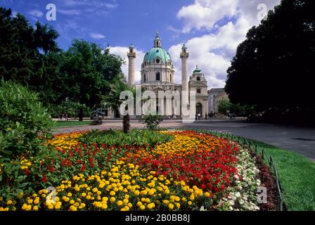AUSTRIA, VIENNA, KARLSKIRCHE, BAROQUE ARCHITECTURE, FLOWERS IN FOREGROUND Stock Photo