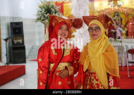 two beautiful girls who are wearing Minang clothes at a wedding in 