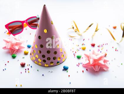 Birthday party caps, decorations and confetti on a white background Stock Photo