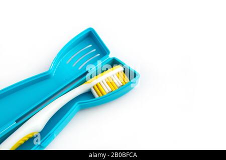 Toothbrush in a plastic case on white background Stock Photo