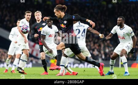 London, UK. 19th Feb, 2020. Football: Champions League, Tottenham Hotspur - RB Leipzig, knockout rounds, last sixteen, first legs, at Tottenham Hotspur Stadium. Leipzigs Yussuf Poulsen (M) against Tottenhams Davinson Sanchez (3rd from left), Serge Aurier (5th from left) and Tanguy Ndombele (right). Credit: Robert Michael/dpa-Zentralbild/dpa/Alamy Live News Stock Photo