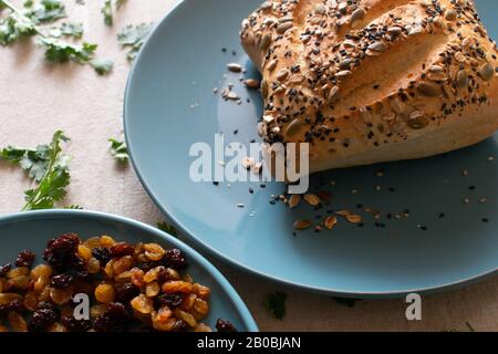 paved bread with sesame seeds on a blue plate Stock Photo